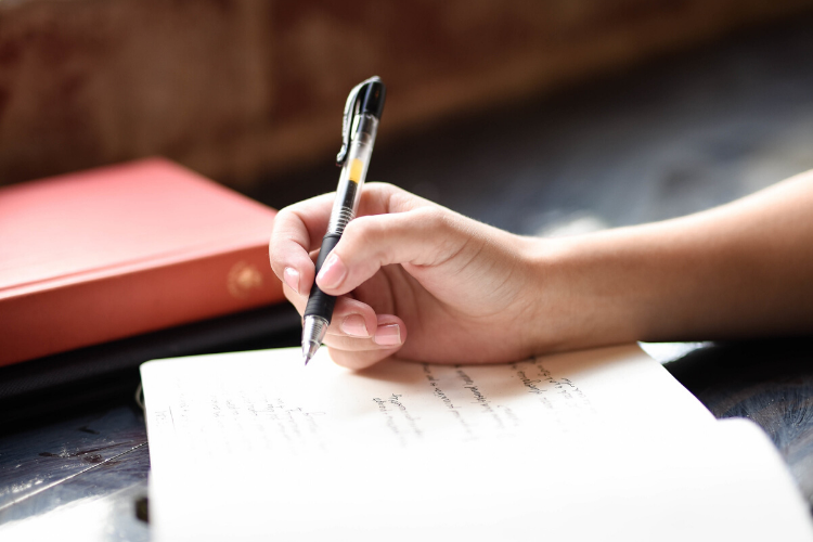 writing on a notebook